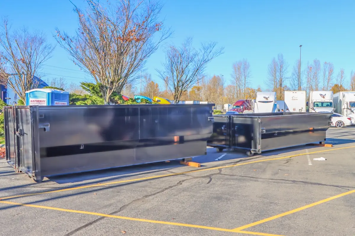 Professional dumpster rental service with roll-off container on residential driveway in Meadville